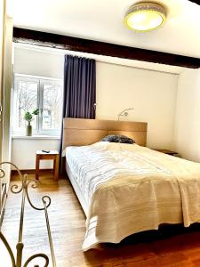 a bedroom with a large bed and a window at Ferienhaus Fischerglück im Herzen von Plau am See in Plau am See