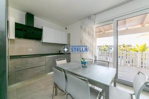a kitchen with a table and chairs in a room at Cala Blu in Lido di Jesolo