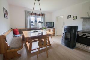 a living room with a table and a fireplace at Chalet Nordwald 