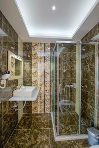 a bathroom with a shower and a sink at Hotel Iliria in Sarandë