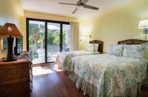 a hotel room with two beds and a balcony at Nautical Adventures in Paradise in Key West +63 photos