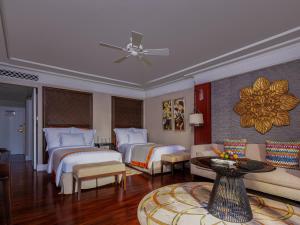 a hotel room with two beds and a couch at InterContinental Bali Resort by IHG in Jimbaran