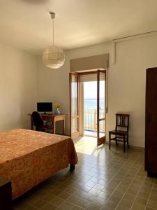 ガリポリにあるPanoramico Appartamento Lido Conchiglieのベッドルーム1室(ベッド1台、デスク、窓付)