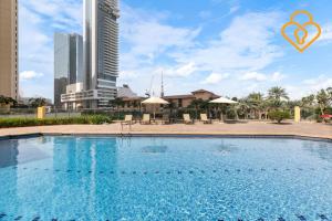 a large swimming pool in a city with tall buildings at Keysplease Modern Studio Near Beach, Murjan JBR 617 in Dubai