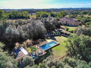 an aerial view of a house with a swimming pool in a yard at Mas Dalia - Turismo Rural - Girona - Monells, Empordà in Monells