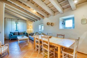 a living room with a table and a couch at Mas Dalia - Turismo Rural - Girona - Monells, Empordà in Monells