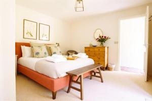 a bedroom with a bed and a wooden table at Gatehouse North in Worstead