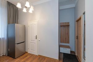 a kitchen with a refrigerator in a room at Old town apartment with free parking by Polo Apartments in Kaunas