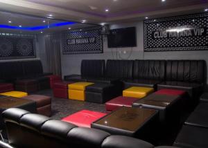 a room with chairs and a couch and a tv at BOSS HOTELS & SUITES in Lagos