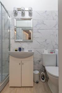 a bathroom with a sink and a mirror at Old town apartment with free parking by Polo Apartments in Kaunas
