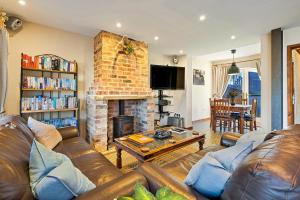 a living room with a couch and a fireplace at Finest Retreats - The Old Smithy in Belchford