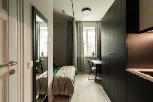 a bedroom with a bed and a desk in a room at MILESTONE Krakow Center Urban Living in Kraków
