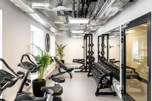 a gym with treadmills and exercise bikes at MILESTONE Krakow Center Urban Living in Krakow