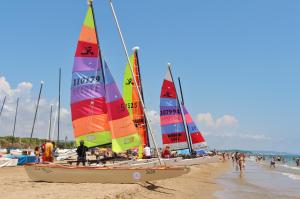 a group of sail boats on a beach at Camping Relax Sol in Torredembarra