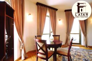 a dining room with a wooden table and chairs at Latar Hotel Yerevan in Yerevan