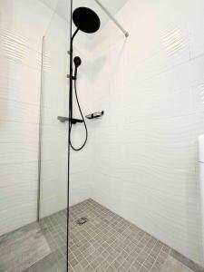 a shower with a glass door in a bathroom at Le Dulys : Apt 2 prs, vue mer, clim, 2 min plages in Antibes