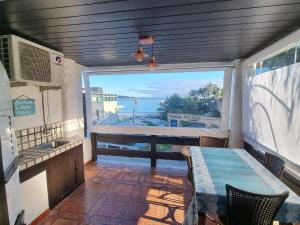 cocina con mesa y vistas al océano en Apartamento com Vista ao Mar, en Bombinhas