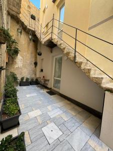 an empty courtyard with a staircase in a building at Marta House 2 in Trapani