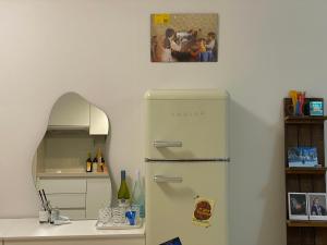 a white refrigerator in a kitchen with a picture on the wall at 오목교 2분, 2 room, netflix, youtube in Seoul