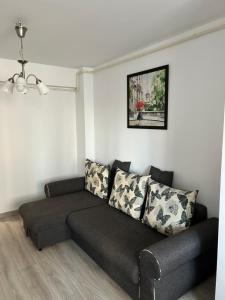 a living room with a couch in a room at Warm Apartament Nou in Bacău