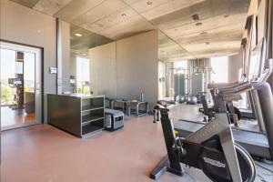 a gym with treadmills and a treadmill at Optimum Apartment - Opfikon in Opfikon