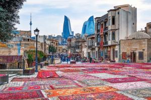 a city street with carpets on the ground with buildings at Bulvar Inn Baku Hotel in Baku
