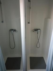 a shower in a bathroom with two benches in it at Glamping Komarno in Jelenia Góra