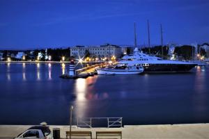 a couple of boats docked in a harbor at night at Luxury Apartment Gloria Old Town Zadar with Sea View in Zadar