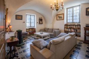 a living room with a couch and a table at Mas Carpe Diem avec piscine privée et wifi in Orthoux-Sérignac-et-Quilhan