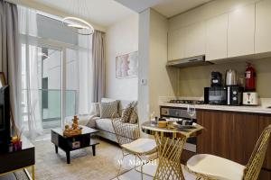 cocina y sala de estar con sofá y mesa en Manzil - 1BR Apartment in Downtown with Canal and Marina Access, near Burj Khalifa, en Dubái