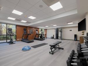 a gym with treadmills and machines and a flat screen tv at Candlewood Suites - Birmingham - Inverness, an IHG Hotel in Birmingham