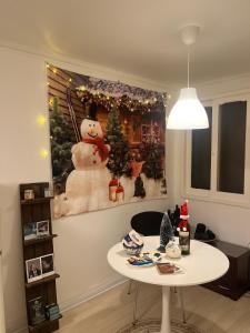 a room with a table and a christmas picture on the wall at 오목교 2분, 2 room, netflix, youtube in Seoul