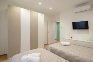 מיטה או מיטות בחדר ב-Don Bi Apartments