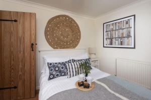 a bedroom with a bed with a tray of food on it at Tathra Beach Cottage in St Ives