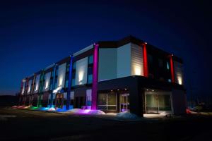 a building with lights on the side of it at night at Days Inn by Wyndham Berthierville in Berthierville