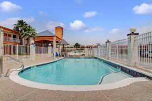 a swimming pool in the middle of a building at Super 8 by Wyndham Galveston in Galveston