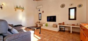 a living room with a couch and a table at Finca con piscina rodeada de naturaleza in Sencelles