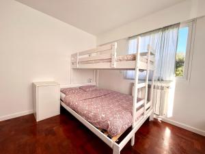 a bedroom with two bunk beds and a window at Hostel do Alto - Fão in Esposende