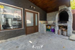 an outdoor kitchen with a stone pizza oven at Casa Zânelor Slănic Moldova in Slănic-Moldova