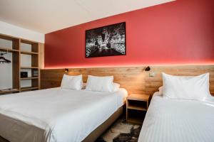 Postel nebo postele na pokoji v ubytování Hotel des Congrès