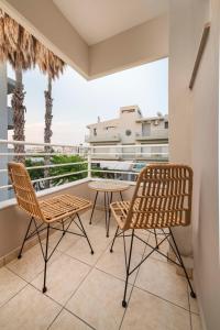 a balcony with two chairs and a table at Gaia 4 - 5 min to Beach in Kos Town
