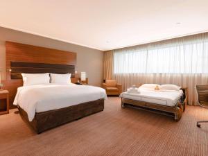 Ένα ή περισσότερα κρεβάτια σε δωμάτιο στο Sofitel London Heathrow