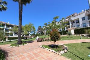 a person sitting on a bench in a park at Great 2-Bed Apartment in Nueva Andalucia Marbella in Marbella