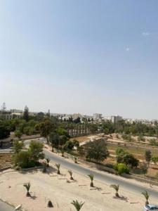 a view of a street with palm trees and a road at Galaxy Hôtel in Sfax