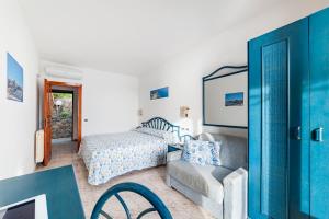 a bedroom with a bed and a couch and a chair at Punta Chiarito Resort in Ischia +37 photos
