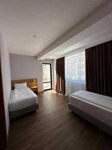 a hotel room with two beds and a window at BANOVANI Bakuriani in Bakuriani