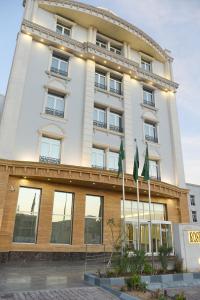 a building with two flags in front of it at Rose Bark - روز بارك in Hafr Al Baten