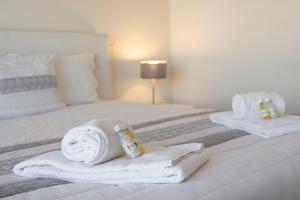 una habitación de hotel con toallas en una cama en TAC - Pêra Gardens Villa, en Pêra