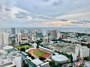 a city with a ballpark in the middle of a city at JC Condo, SMDC Green Malate Taft Manila in Manila