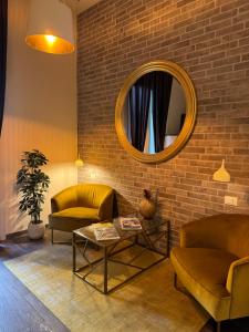 a living room with two couches and a mirror at Maglo Station in Bologna